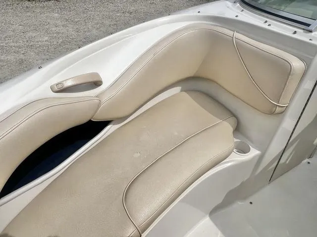 Slide: The Image of 2000 Sea Ray 210 Signature Bowrider interior with beige seating and cup holder. - 16