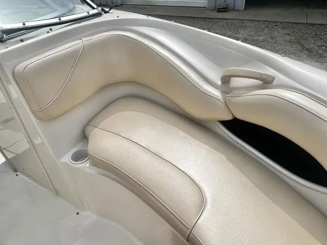 Slide: The Image of 2000 Sea Ray 210 Signature Bowrider interior with beige leather seating and cup holder. - 17