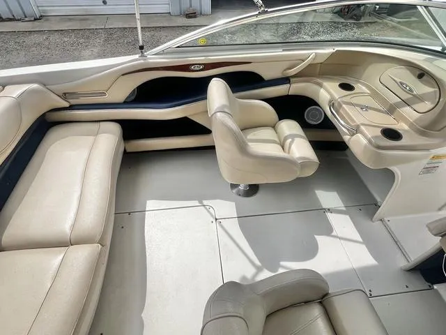 Slide: The Image of Interior of a 2000 Sea Ray 210 Signature Bowrider with beige seating and helm. - 22