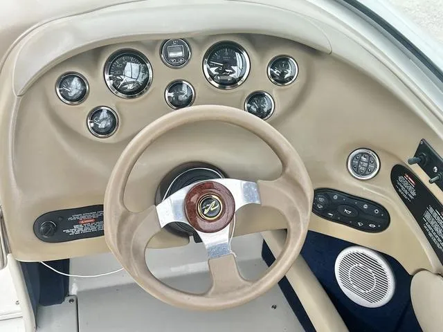Slide: The Image of Dashboard of a 2000 Sea Ray 210 Signature Bowrider with gauges and steering wheel. - 24