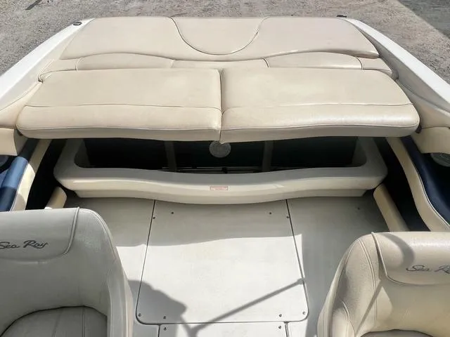 Slide: The Image of 2000 Sea Ray 210 Signature Bowrider interior with beige seating and spacious layout. - 26