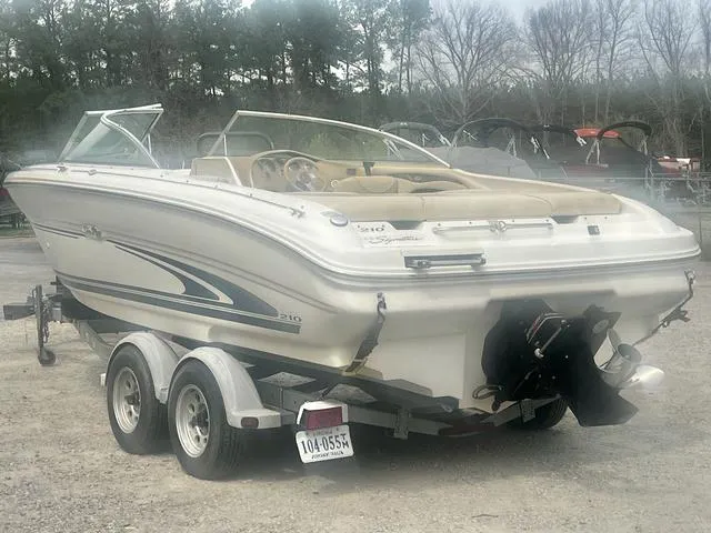 Slide: The Image of 2000 Sea Ray 210 Signature Bowrider on trailer, parked outdoors. - 5