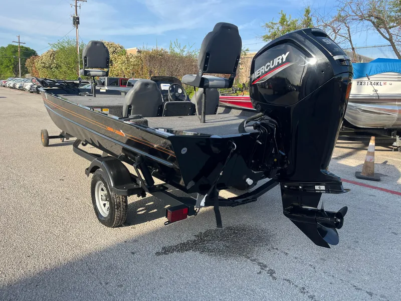 Slide: The Image of 2022 Lowe Legacy boat on trailer in parking lot, sunny day. - 19