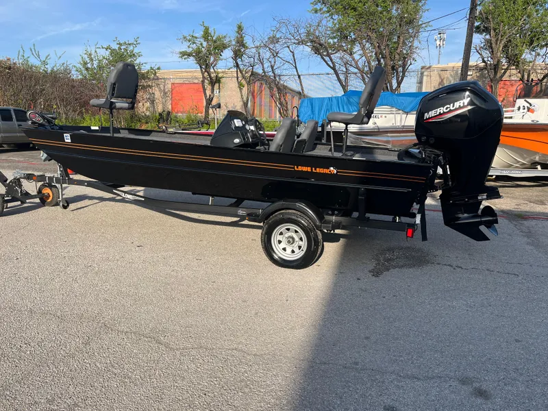 Slide: The Image of 2022 Lowe Legacy boat with Mercury engine on trailer, parked outdoors. - 20