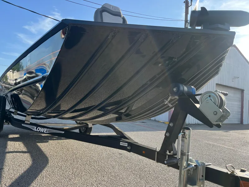 Slide: The Image of 2022 Lowe Legacy boat on trailer, parked on street, sunny day. - 23