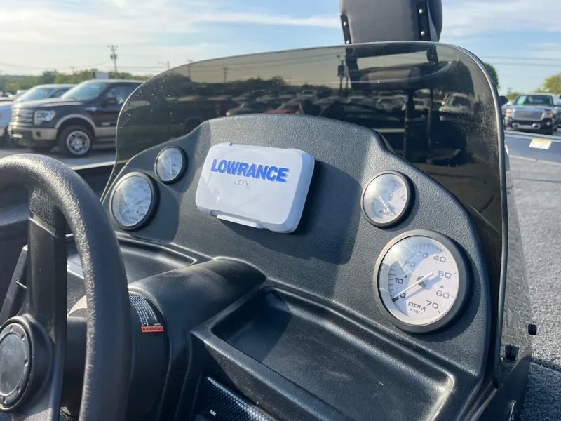 Slide: The Image of Steering console of a 2022 Lowe Legacy boat with Lowrance electronics, parked outdoors. - 29