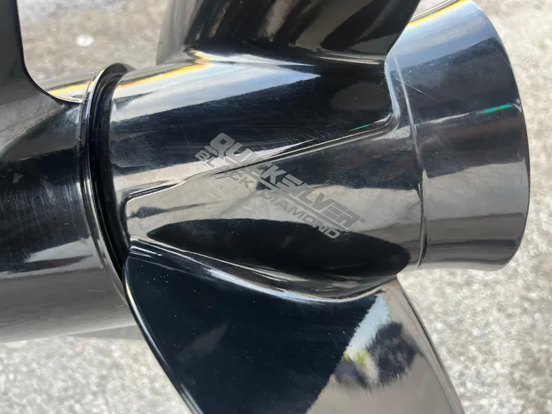 Slide: The Image of Black boat propeller on a 2022 Lowe Legacy, displayed on a concrete surface. - 31