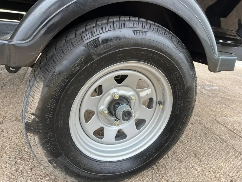 Slide: The Image of 2022 Lowe Legacy trailer tire on asphalt surface. - 42