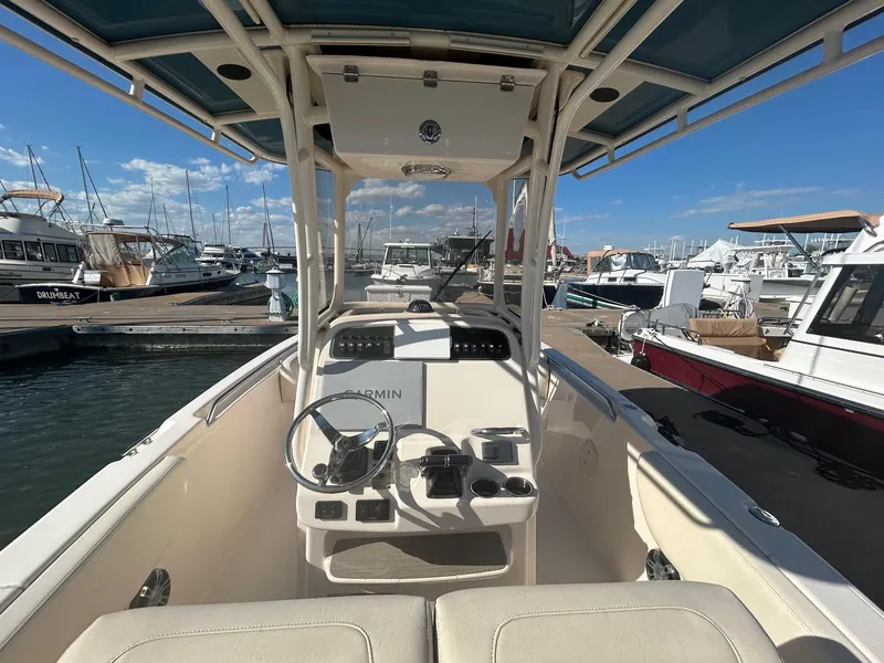 Slide: The Image of 2020 Grady-White Fisherman 257 boat at marina, featuring helm and seating area. - 5