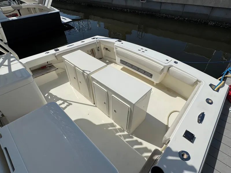 Slide: The Image of 2007 Albemarle 410 Express Fisherman boat deck with storage cabinets and seating. - 11