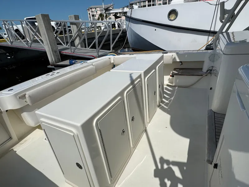 Slide: The Image of 2007 Albemarle 410 Express Fisherman boat deck with storage compartments at marina. - 15