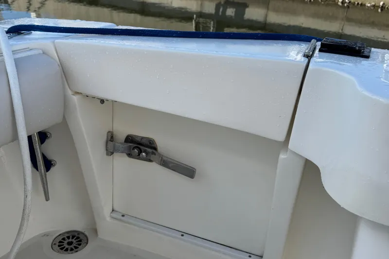 Slide: The Image of 2007 Albemarle 410 Express Fisherman boat interior detail with storage compartment and latch. - 17