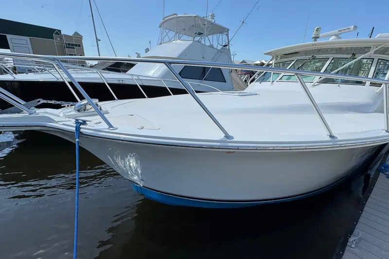 Slide: The Image of 2007 Albemarle 410 Express Fisherman boat docked in marina, side view. - 2
