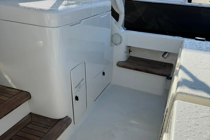 Slide: The Image of 2007 Albemarle 410 Express Fisherman boat interior with wooden steps and storage compartments. - 20