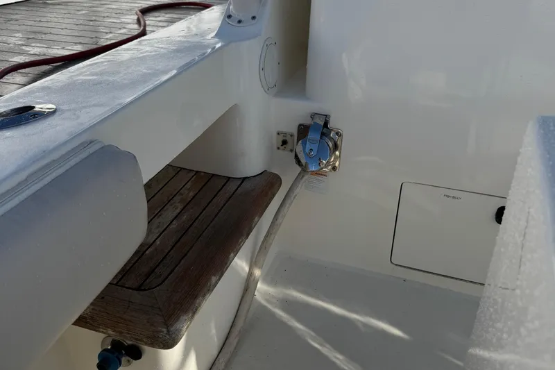 Slide: The Image of 2007 Albemarle 410 Express Fisherman boat interior with wooden seat and white deck. - 21