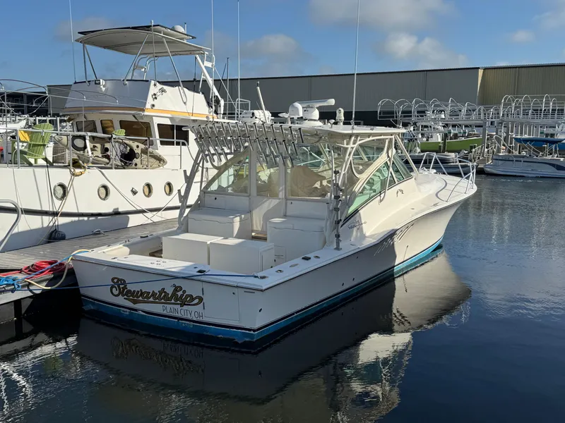 Slide: The Image of 2007 Albemarle 410 Express Fisherman boat docked in a marina, clear sky reflection. - 3