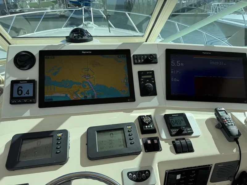 Slide: The Image of 2007 Albemarle 410 Express Fisherman dashboard with navigation and control displays. - 32