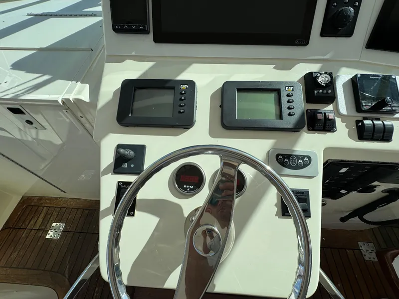 Slide: The Image of Helm of 2007 Albemarle 410 Express Fisherman with navigation instruments and steering wheel. - 34