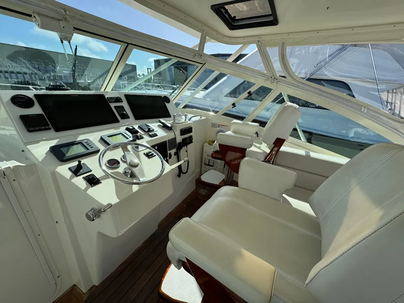 Slide: The Image of 2007 Albemarle 410 Express Fisherman helm with modern controls and comfortable seating. - 35