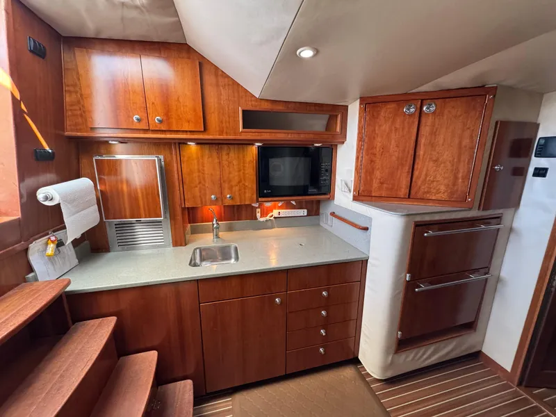 Slide: The Image of 2007 Albemarle 410 Express Fisherman yacht kitchen with wood cabinetry and modern appliances. - 46