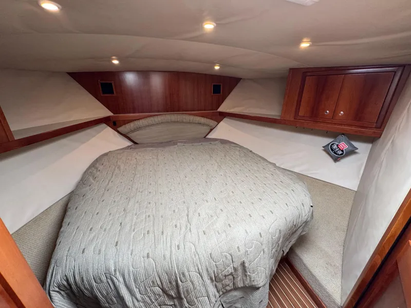 Slide: The Image of Cozy cabin interior of 2007 Albemarle 410 Express Fisherman with wood accents and bed. - 48