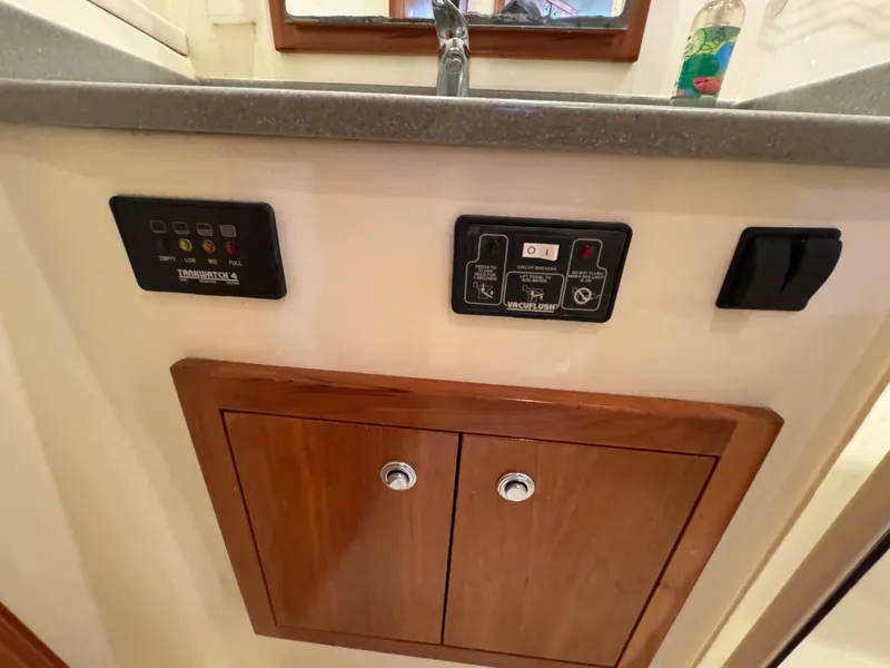 Slide: The Image of Control panel and cabinet on 2007 Albemarle 410 Express Fisherman boat interior. - 52