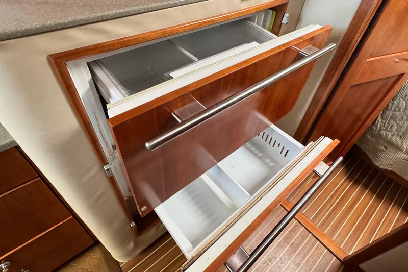 Slide: The Image of 2007 Albemarle 410 Express Fisherman interior with open wooden drawers and storage compartments. - 55