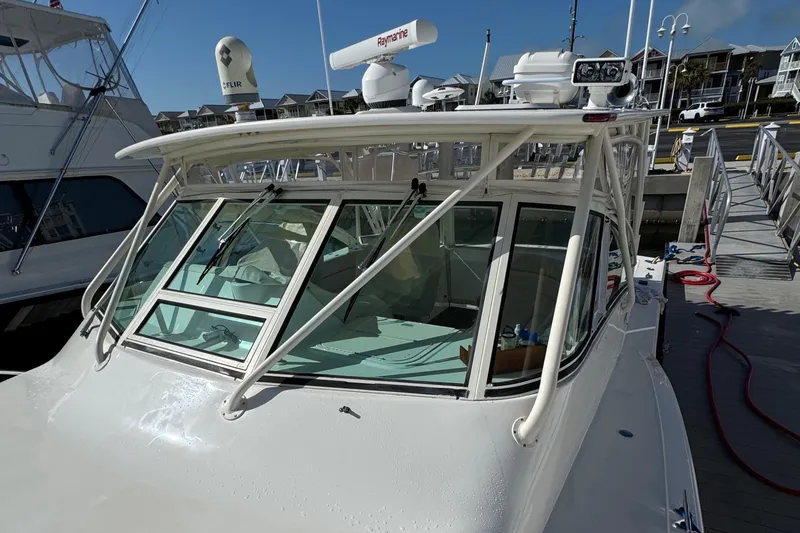 Slide: The Image of 2007 Albemarle 410 Express Fisherman boat docked, featuring a sturdy cabin and advanced radar equipment. - 7