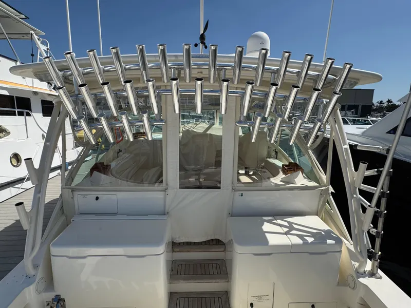Slide: The Image of 2007 Albemarle 410 Express Fisherman boat with multiple rod holders, docked at a marina. - 9