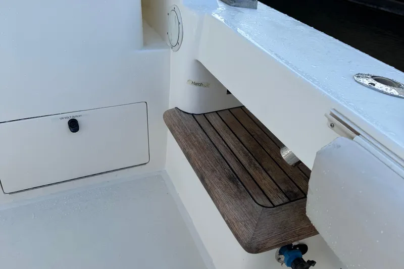 Slide: The Image of 2007 Albemarle 410 Express Fisherman boat deck with wooden seat and storage compartment. - 22