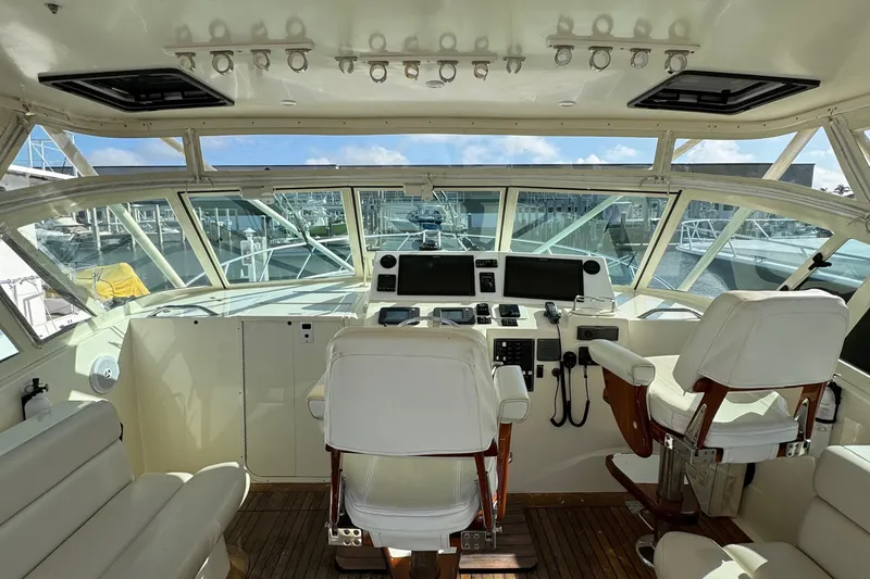 Slide: The Image of 2007 Albemarle 410 Express Fisherman helm with white seating and navigation equipment. - 28