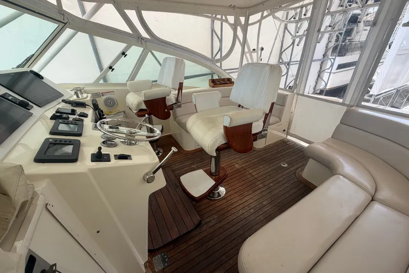 Slide: The Image of 2007 Albemarle 41 Express yacht interior with helm, seating, and wooden flooring. - 25