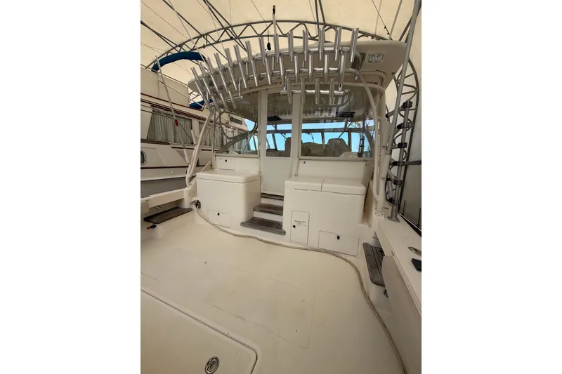 Slide: The Image of 2007 Albemarle 41 Express boat interior with rod holders and seating area. - 14