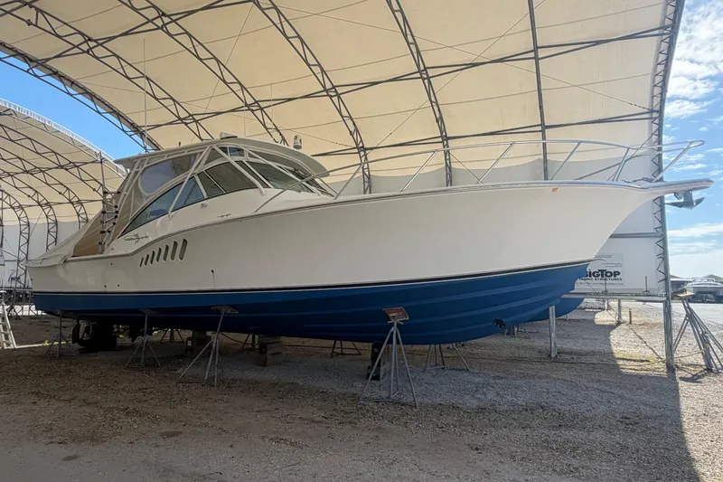 Slide: The Image of 2007 Albemarle 41 Express boat in dry dock under a large canopy. - 79