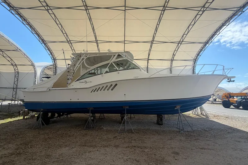 Slide: The Image of 2007 Albemarle 41 Express boat under a canopy, displayed on stands. - 87