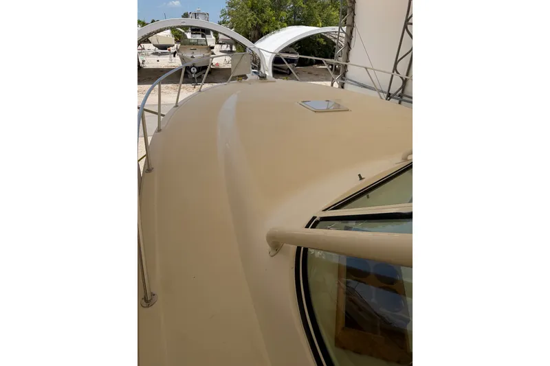 Slide: The Image of 2007 Albemarle 41 Express boat deck with railing, docked under canopy. - 20