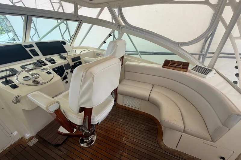 Slide: The Image of Helm of 2007 Albemarle 41 Express boat with white seating and wooden flooring. - 27