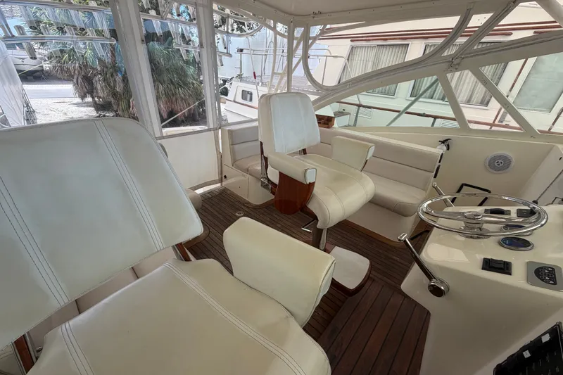Slide: The Image of 2007 Albemarle 41 Express boat interior with white seating and wooden flooring. - 26
