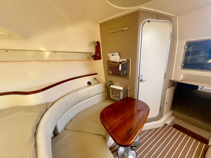 Slide: The Image of 2007 Grady-White Express 330 cabin interior with seating and wooden table. - 16