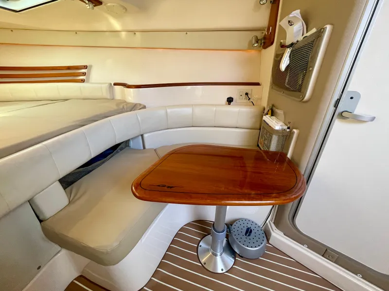 Slide: The Image of 2007 Grady-White Express 330 cabin interior with wooden table and cushioned seating. - 17