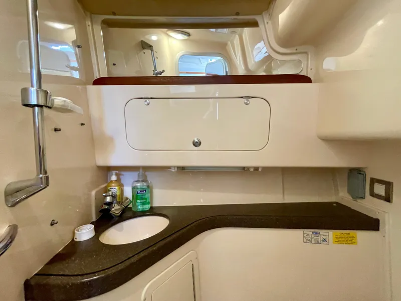 Slide: The Image of 2007 Grady-White Express 330 boat interior with sink and storage cabinet. - 19