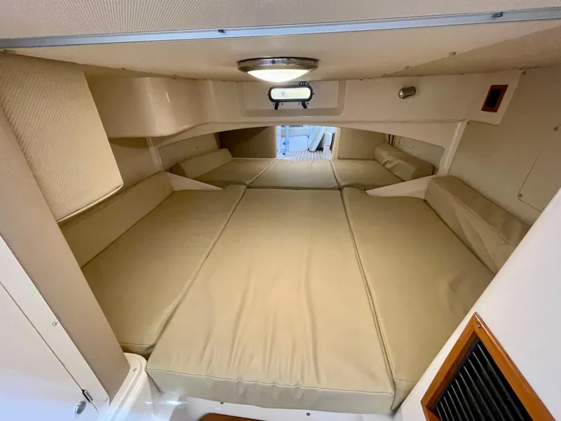 Slide: The Image of 2007 Grady-White Express 330 cabin interior with beige cushions and compact design. - 23