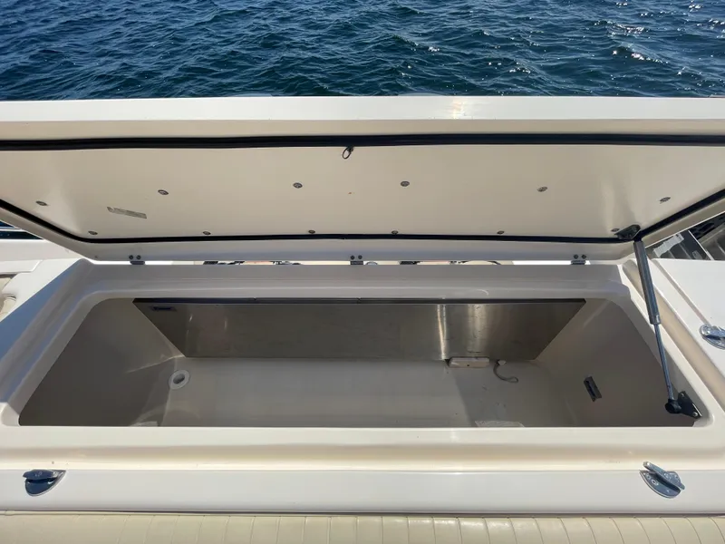 Slide: The Image of Open storage compartment on 2007 Grady-White Express 330 boat, with ocean in background. - 27