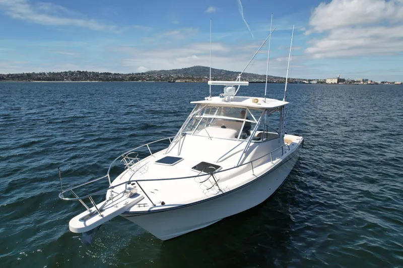 Slide: The Image of 2007 Grady-White Express 330 boat on open water under blue sky. - 4