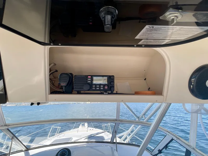 Slide: The Image of 2007 Grady-White Express 330 boat dashboard with radio equipment and ocean view. - 40