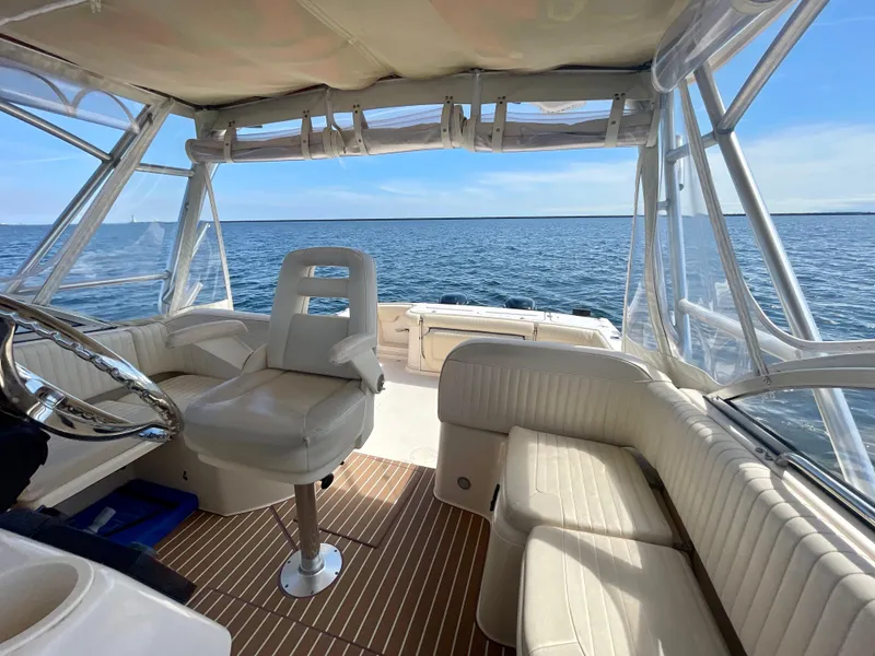 Slide: The Image of 2007 Grady-White Express 330 boat interior with ocean view, featuring helm and seating area. - 44