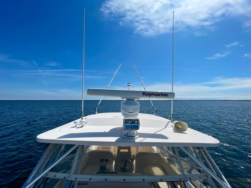 Slide: The Image of 2007 Grady-White Express 330 boat on open water under clear blue sky. - 46