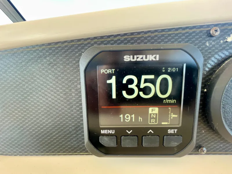 Slide: The Image of Suzuki engine display showing 1350 RPM on a 2007 Grady-White Express 330 boat. - 49