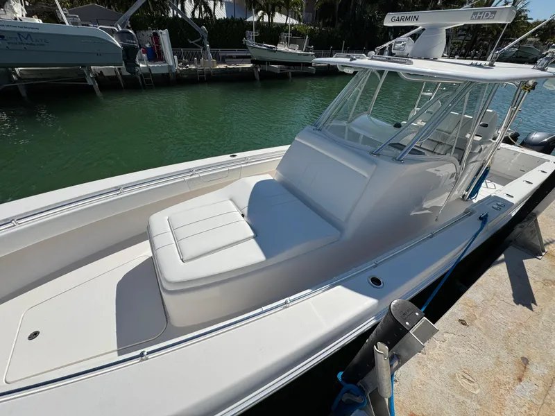 Slide: The Image of 2021 Contender 39 Fisharound boat docked, featuring sleek design and spacious seating. - 10