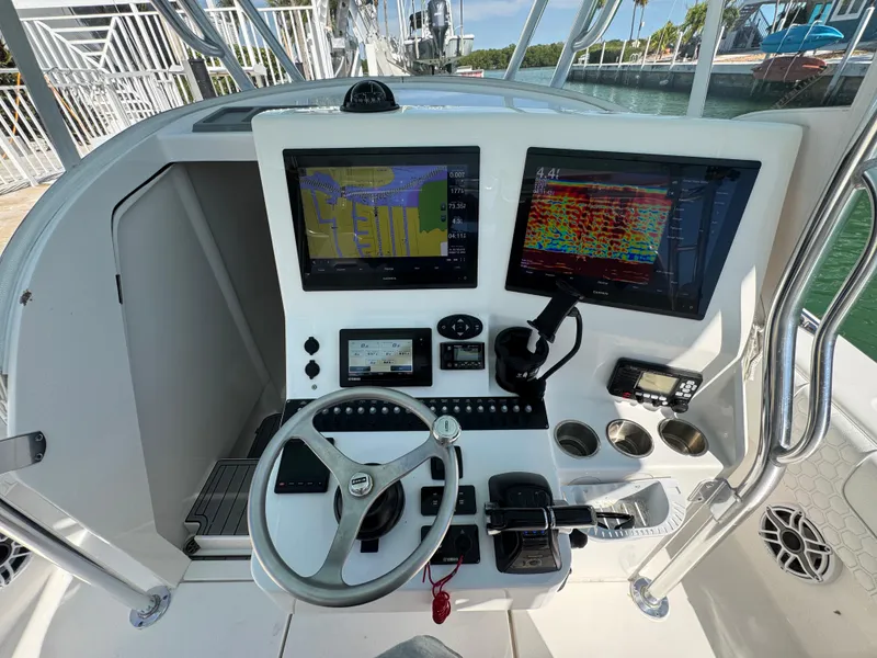 Slide: The Image of 2021 Contender 39 Fisharound helm with dual navigation screens and steering wheel. - 14